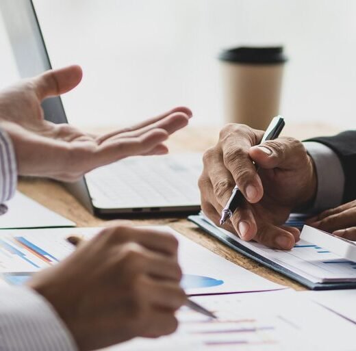 Financial advisor meeting is discussing the analysis of financial reports and business auditing.